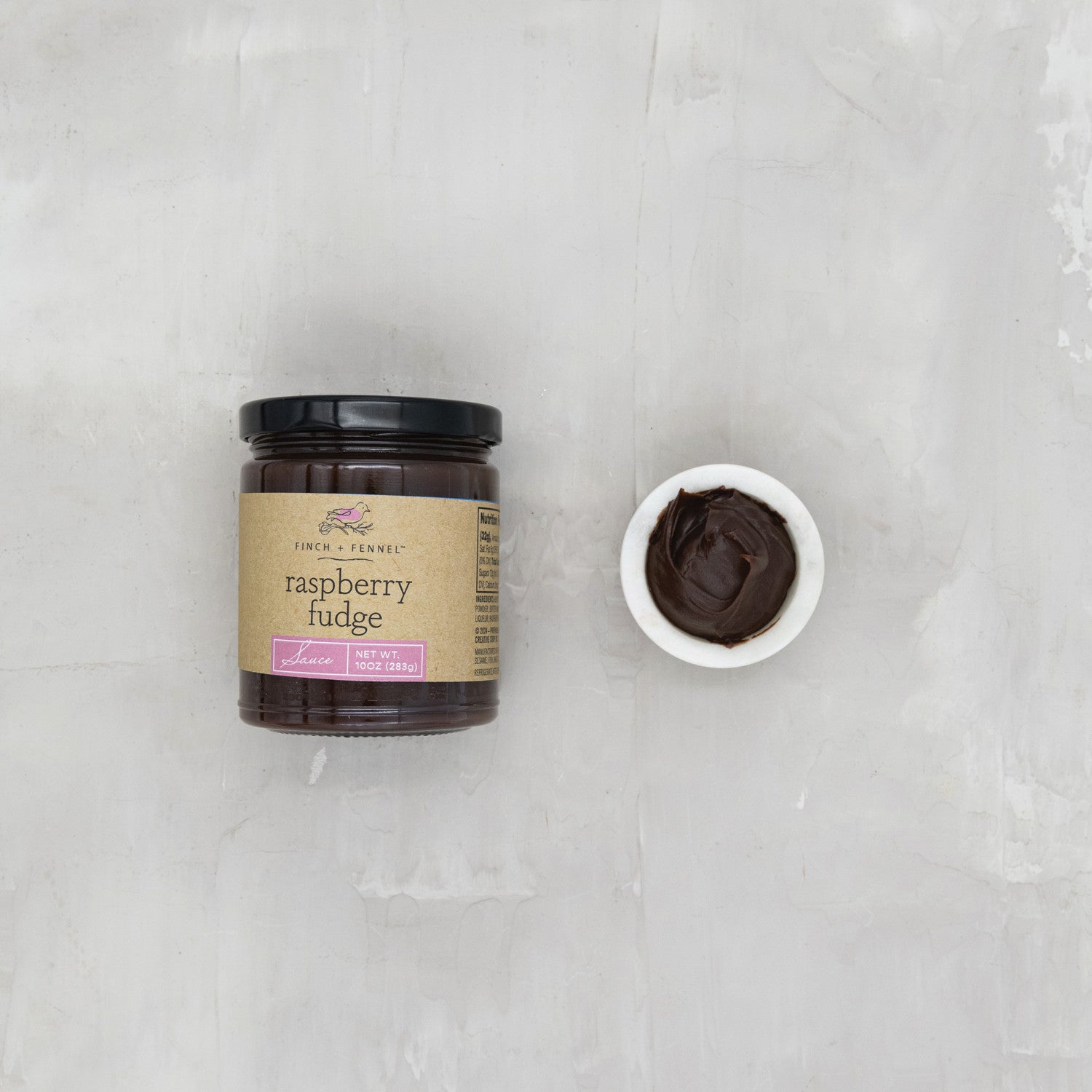 Indulge in the rich, deep flavor of our 10 oz. Raspberry Fudge Sauce. This decadent sauce combines creamy, dark chocolate fudge with the bright, tart sweetness of real raspberries. Perfect for pouring over ice cream, drizzling on cakes, or enjoying straight from the spoon. A luxurious treat for any dessert lover.