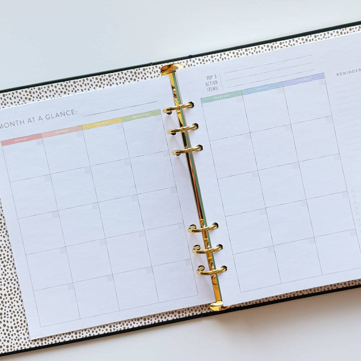 Open planner with monthly layout on a white surface