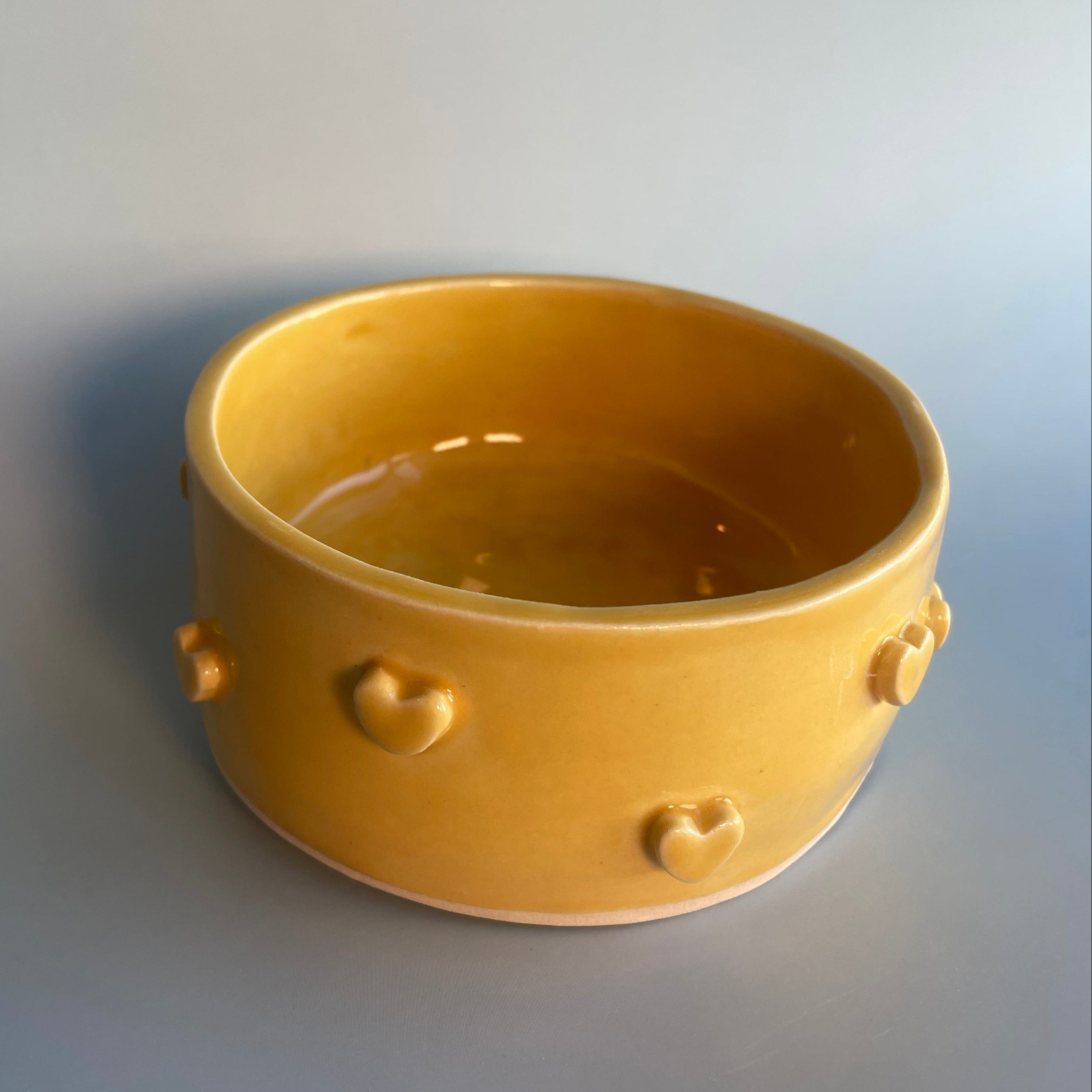 12 oz yellow ceramic bowl with hearts on the sides