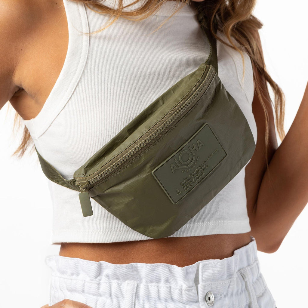 Whether you want to carry a snack, pack your phone, or speed through TSA, this olive color hip pack helps you do it all hands-free. Store your cash, credit cards, and hotel keys in a handy inside zipper pocket and easily access your ID or passport during air travel or train transit. It's great for traveling, hiking, biking, and everyday adventures. With its versatile design, you can wear it as a crossbody bag or around your waist.