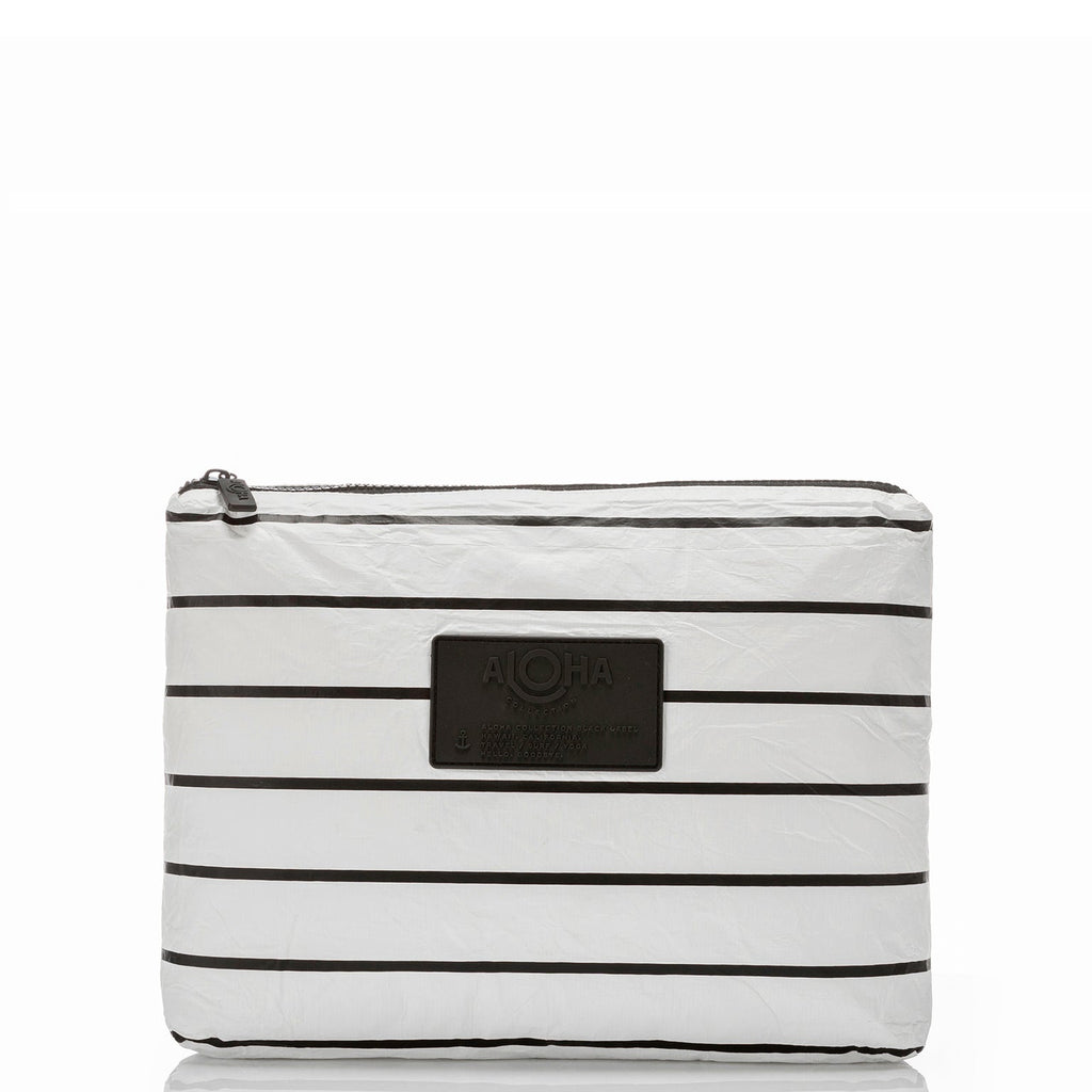 This black/white multi-tasking Mid pouch is an excellent option for travel. Use it to stow accident-prone toiletries to eliminate leaks from happening inflight. You can also use it to pack tech and travel gear to keep your carry-ons organized and items like chargers and power cords within reach. Packing for a beach day? Toss in sunscreen, sunnies, pareo, book, a comb, and your coverup inside.
