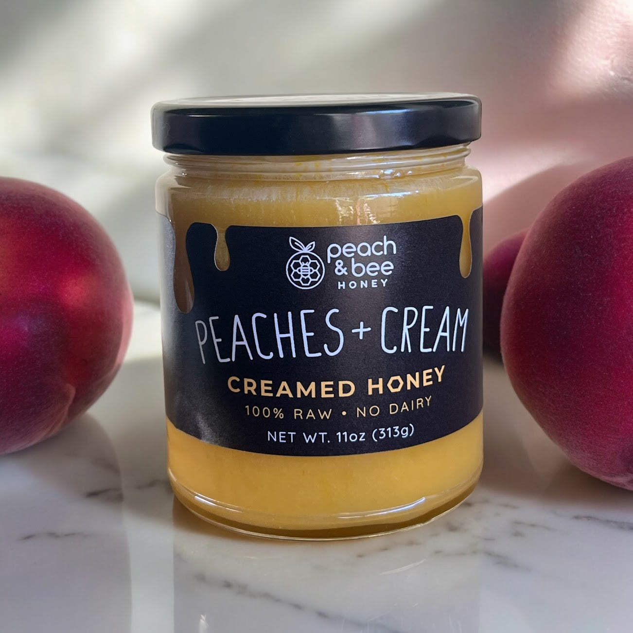 A jar of Peach & Bee creamed honey peaches & cream flavor