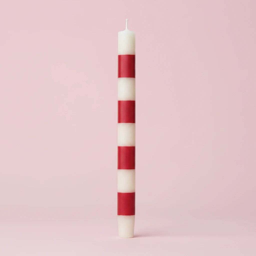 Set the mood with our Unscented Taper Candles featuring playful stripes. Includes a set of two candles in a convenient box. No need for overpowering scents, just enjoy the warm, flickering light. Perfect for any occasion, without taking itself too seriously. Red & White Striped