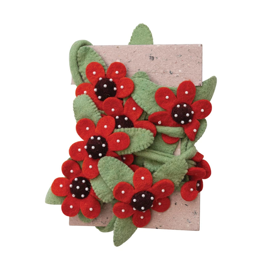 Give your home a flower-filled makeover with this one-of-a-kind handmade wool felt flower garland! Its vibrant colors will bring life to any room and its charming beads will provide that extra bit of bling. It's sure to become the 'bella of the ball!        Size  72"L 