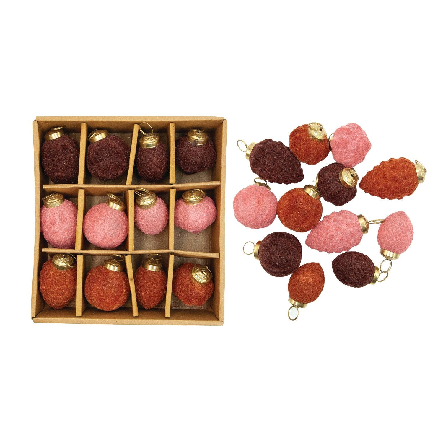 Set of red and pink Christmas ornaments in a wooden box with additional ornaments displayed on a white background.