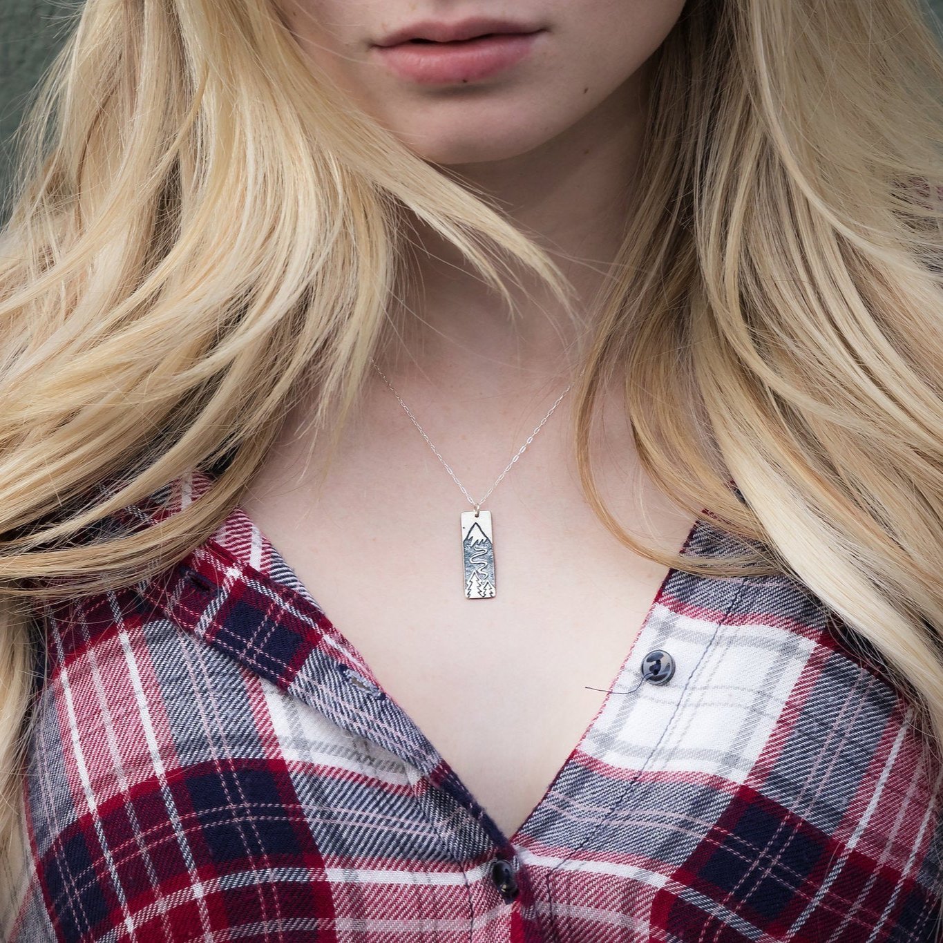 Solid Sterling Silver pendant. Polished finish on the front. Satin finish on the back. Solid Sterling Silver chain.