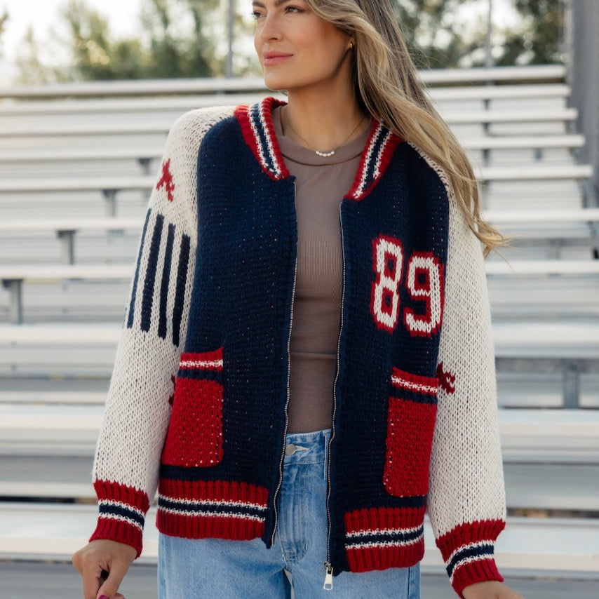 This sporty retro cardigan features a zip front + a letterman design. Perfect for those of us going back to school this year! A chunky knit and oversized fit give this cardi a cool girl look that you'll love this fall!