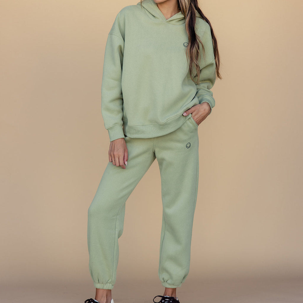 We got nothing but smiles here at ROOLEE :) These soft, french terry sweatpants feature an embroidered smiley face graphic, elastic waistband, + working pockets. The fit on these is perfect for cozying up next to the Christmas tree or running around town getting your Christmas shopping done. 