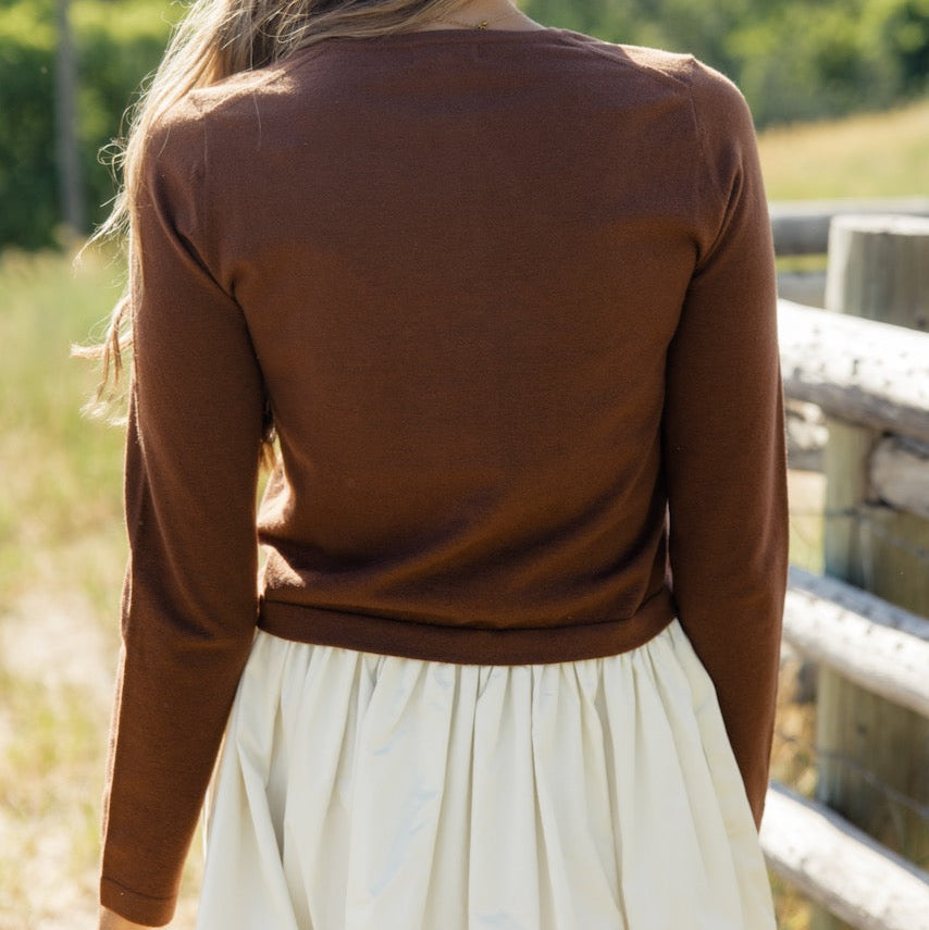 Who doesn't love a cardigan that can double as a top? The Down Bad Button Cardigan features a round neckline, functional buttons, and a cropped fit. We love it buttoned up for a fun take on a simple long-sleeve tee!