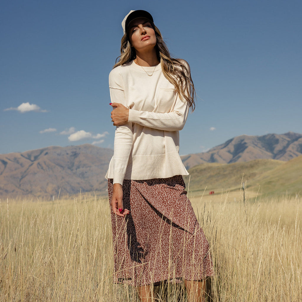 Featuring a playful high-low hemline and whimsical side slits, this sweater is as stylish as it is comfy! With ribbed details, a patch pocket, and a relaxed boxy fit, you'll feel warm and wonderful all day long. Ivory