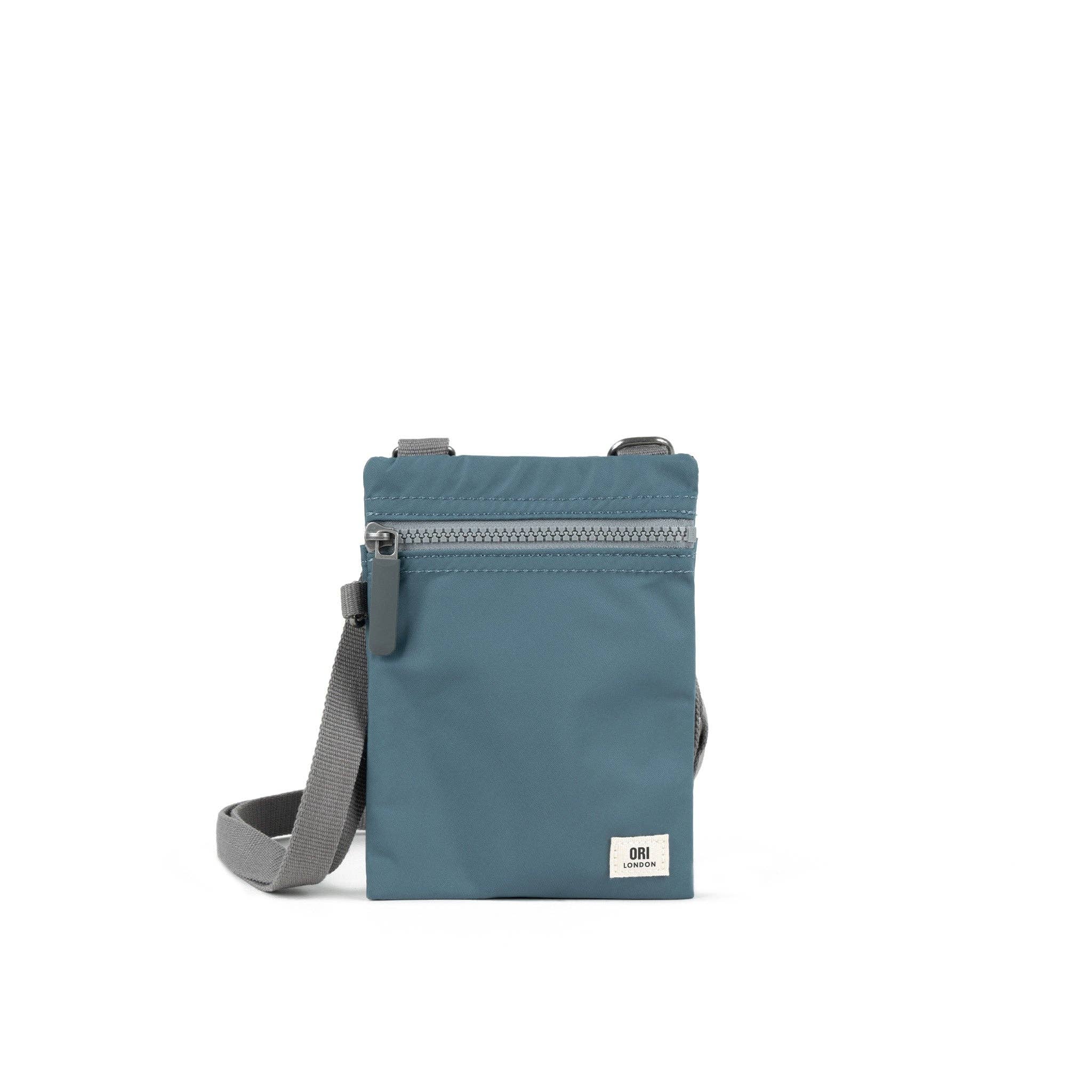 Our hands-free extra pocket is always by your side. The Chelsea is our great little crossbody pocket to keep those special things close and safe. Airforce Blue

Give your phone, card and essentials their very own stylish way to be carried whilst you are on the move. Our brand-new Chelsea collection is the perfect lightweight, urban accessory for you to travel light and always be on the move.

Made from recycled material, the Chelsea has been designed to keep your mobile phone, cards, and valuables close by.