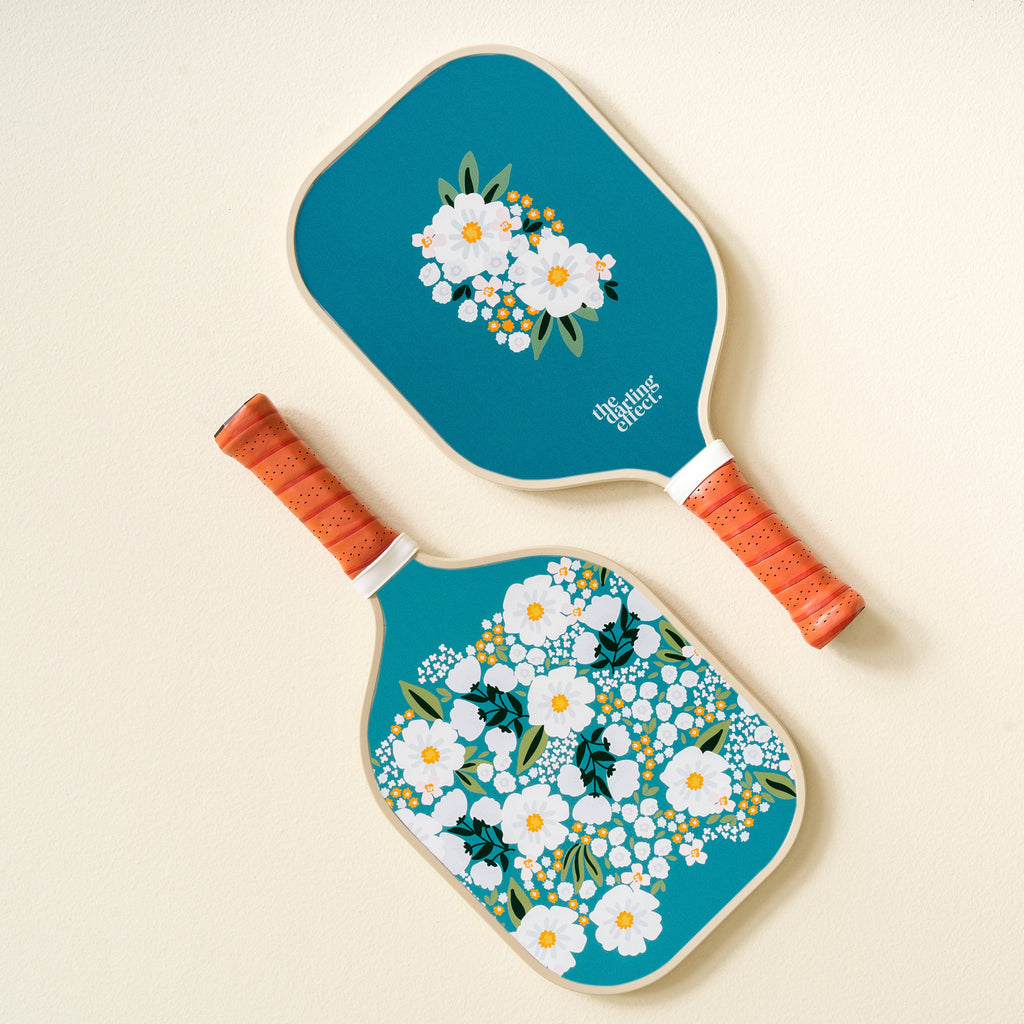 Are you ready to elevate your pickleball game and turn heads on the court? Look no further! Our top-quality pickleball paddles are here to make your pickleball experience truly exceptional. Our top-notch paddles combine fun and femininity, offering a unique look that sets you apart from the competition. Play with passion and style – it's what we're all about.

Details:

Dimensions: 15.7”H x 7.8” W
weight 7.5-8 oz
High condensed foam covered with a vegan leather grip
High-quality; built to last
Core is .51” 