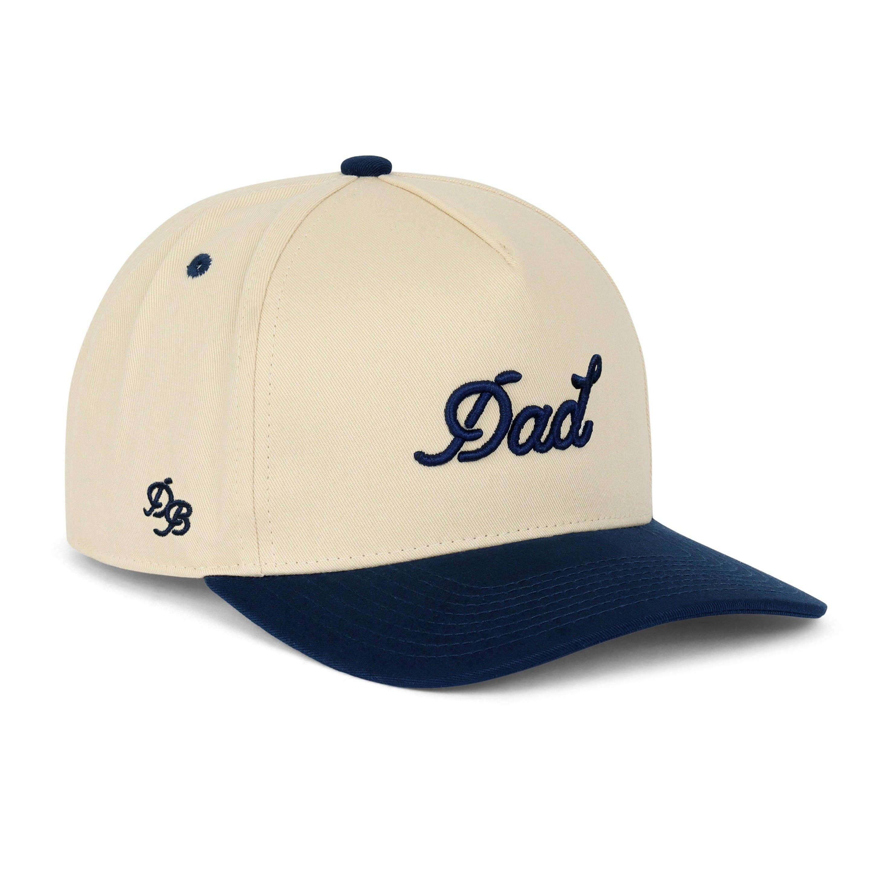 The Dad 3D Puff Snapback in cream and navy is a clean, giftable two-tone hat built for dads, new dads, grandpas, and anyone who wears the title proudly. Featuring bold 3D puff embroidered "Dad" lettering, a structured high-profile crown, and a slightly curved brim.