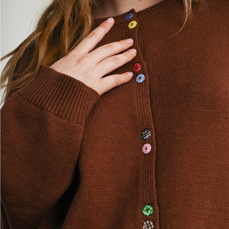 Brown knit long-sleeved cardigan with colorful gingham functioning buttons along front. 