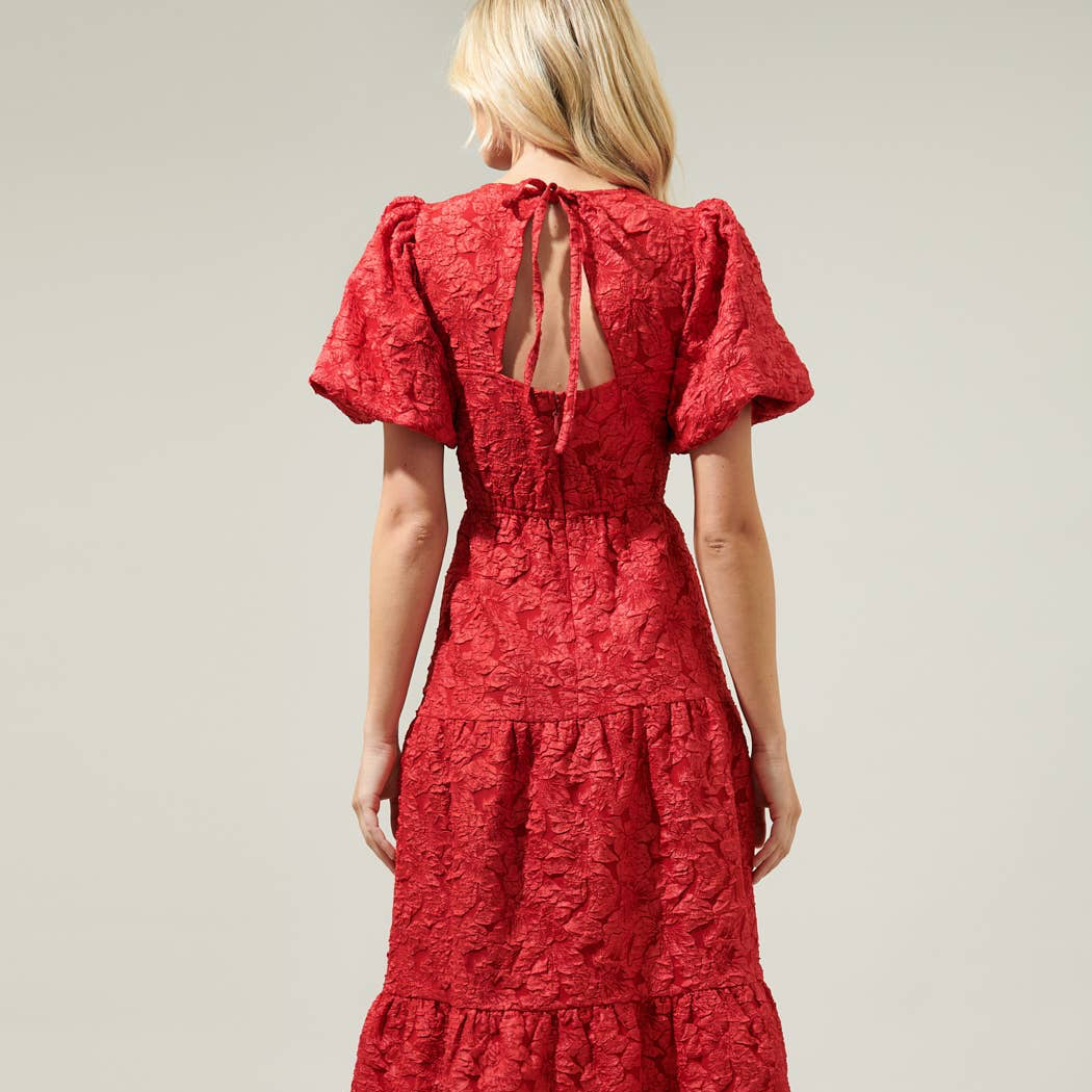 Beautiful days deserve beautiful style like the Arielle Luna Poplin Floral Maxi Dress! Made from a lightweight fabric, it features a shallow v neckline with floral details all down. The puff balloon sleeves and open back sit on the tiered bottom skirt. Pair the look with white or nude mules and you're good to go.

Details:

Puff sleeves
V-neckline
Open back
Tiered
Model is 5'8" and wearing size XS
Measurements taken from size S - Chest: 17 1/4" - Length: 54 1/2"
Color: Red
