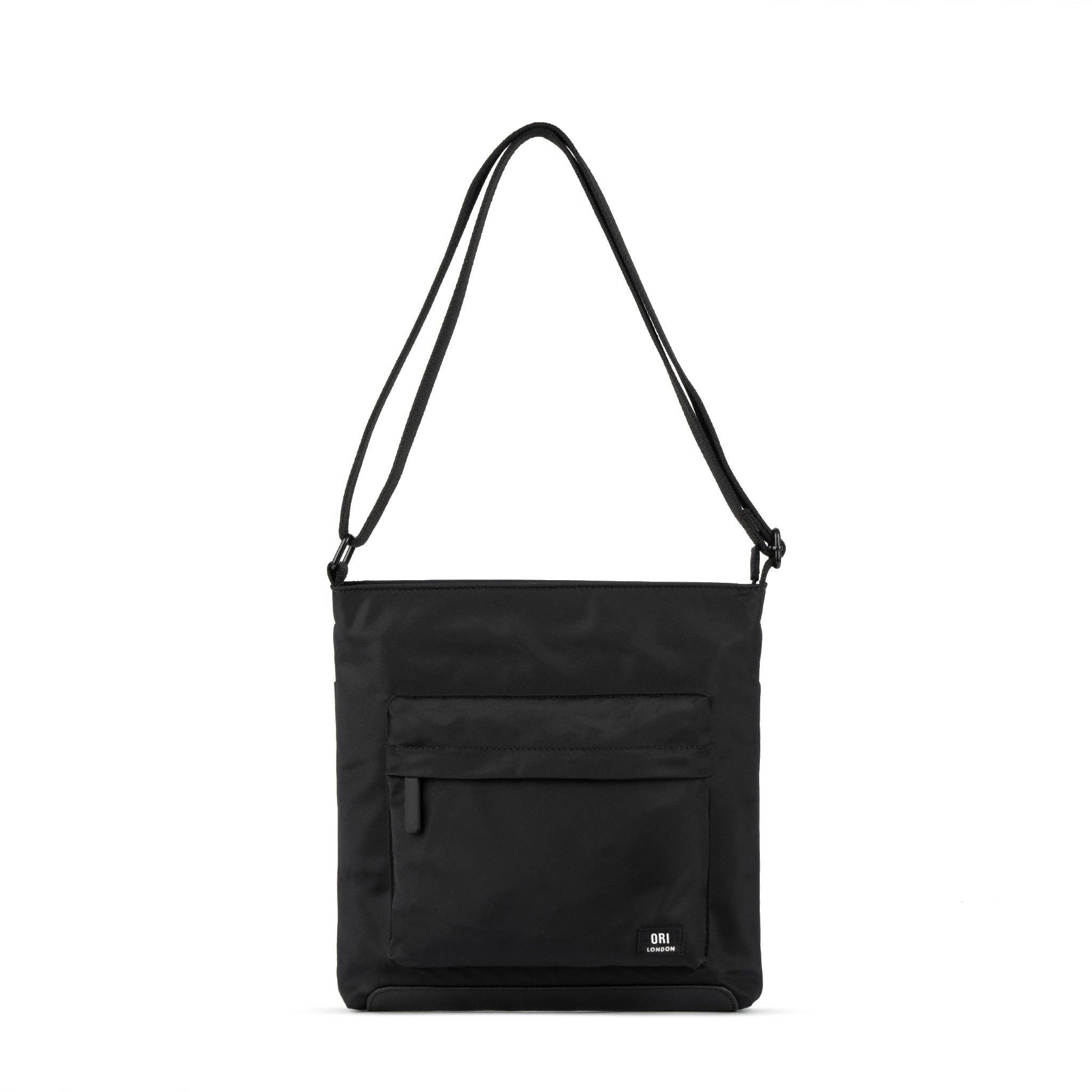 This black crossbody bag is perfect for any occasion – effortlessly taking you from day to night! Wear on the shoulder or across the body, this bag will fit all of your essentials in it and close to hand. With a zipped pocket on the front, a pocket on the back and additional pockets on the inside, you have the perfect bag to organize all of your belongings. The bold chunky zips and weather-resistant recycled nylon material gives you a smooth look and finish to take on any day, rain or shine!
