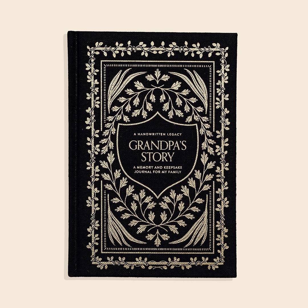 A black and gold keepsake journal titled 'Grandpa's Story: A Memory and Keepsake Journal For My Family' with an elegant linen cover and gold foil cover design.