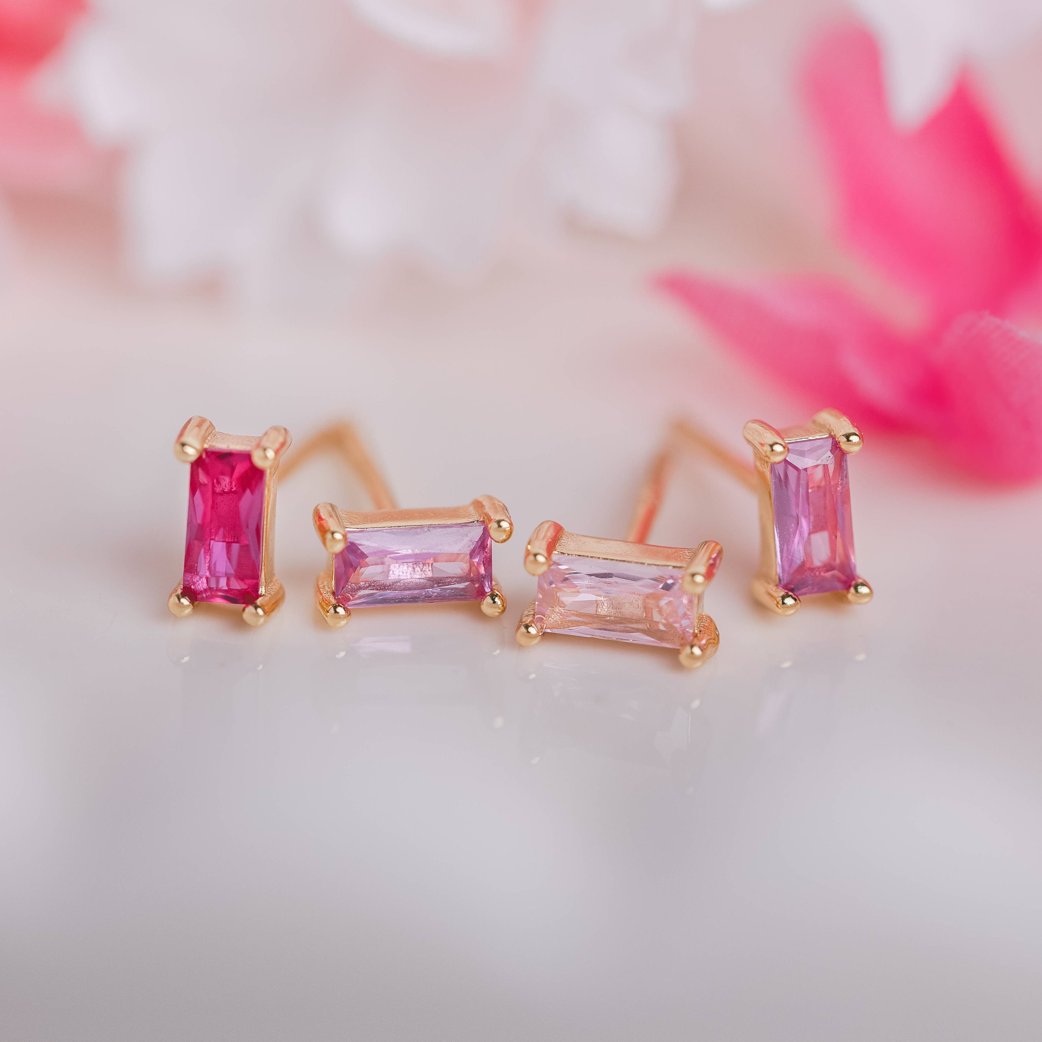  Birthstone Ombre Baguette Stud Earring Set, a collection of four stunning earrings crafted in 18k gold plated with an anti-tarnish coating. This set of stud earrings showcases the ombre effect, seamlessly blending hues from light to dark, creating a captivating visual representation of your birthstone's color spectrum. 
