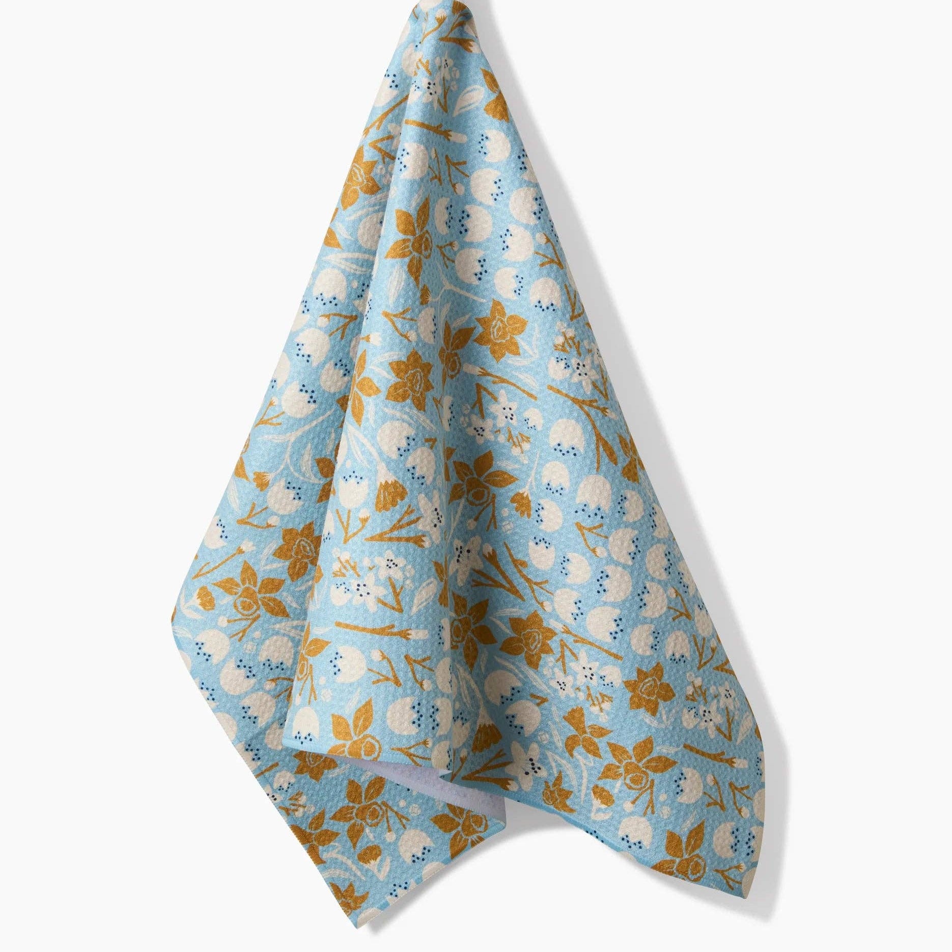 Floral patterned towel hanging on a white background Tea Towel