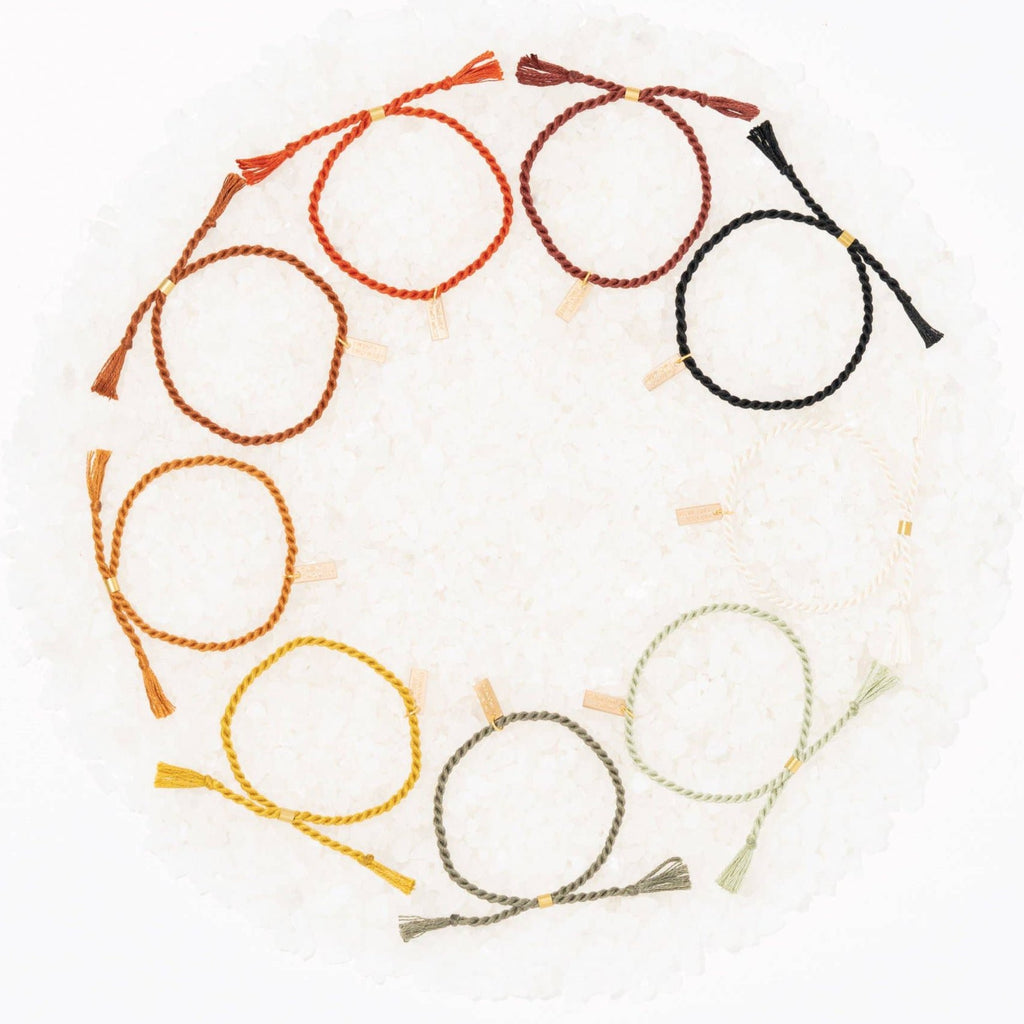 A delicate twist on Twenty Two West's crowd-favorite rope bracelets. The rope is hand spun from a single hue of cotton threads to create this soft and comfortable adjustable bracelet. Wear them individually or collect them all to mix-and-match in a complementary stack! Autumn color.