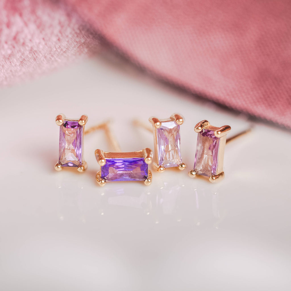 Birthstone Ombre Baguette Stud Earring Set, a collection of four stunning earrings crafted in 18k gold plated with an anti-tarnish coating. This set of stud earrings showcases the ombre effect, seamlessly blending hues from light to dark, creating a captivating visual representation of your birthstone's color spectrum. 