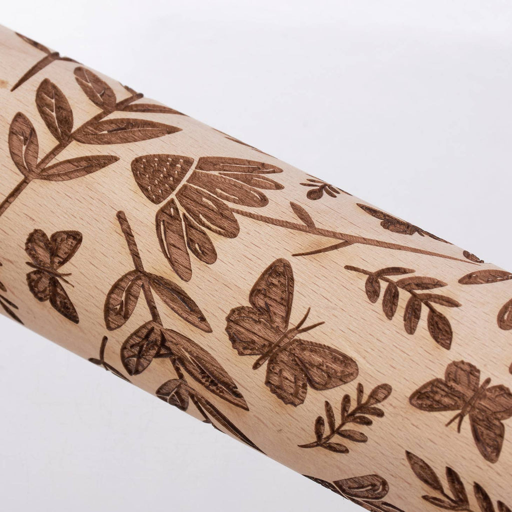 Wooden rolling pin from the Cottagecore Collection with debossed details along the roller that leave fun imprints in dough. This Butterfly embossed rolling pin features natural beech wood debossed with a design of butterflies mixed with a variety of florals. Hand-wash recommended.
