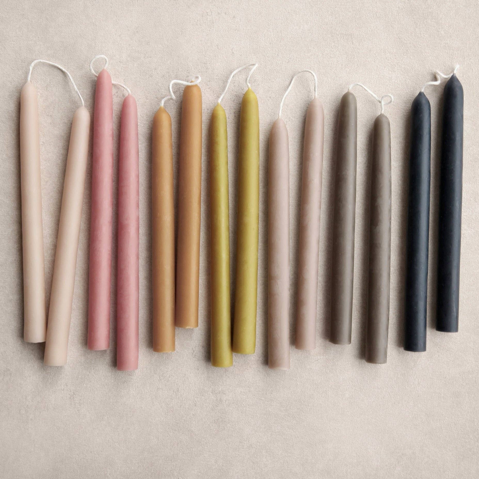 Row of colorful candles on a neutral background