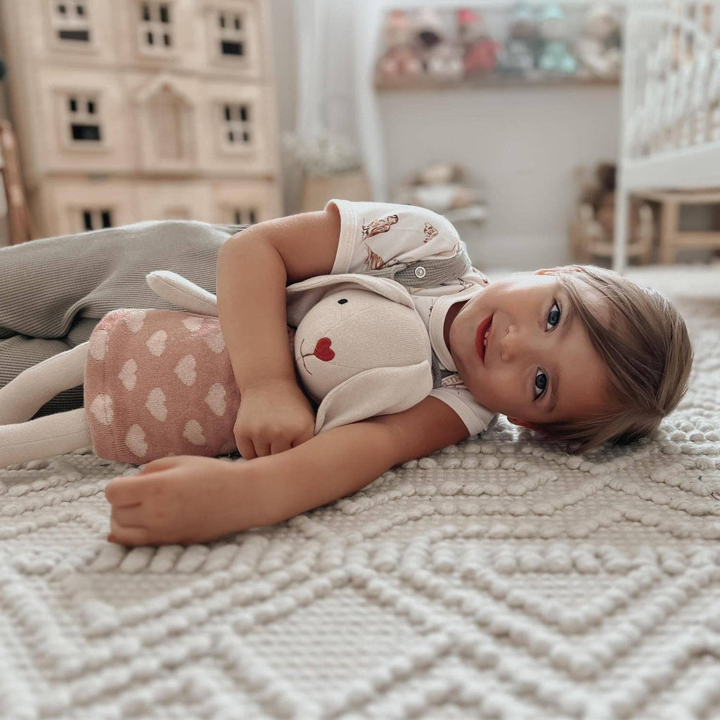 Hop into fun with our Knit Bunny Plush - Luella! This cuddly companion is the perfect blend of softness and playfulness. Made with high-quality knit fabric, Luella is ready to be your new best friend. Perfect for snuggles and imaginative adventures, bring home Luella today!     • 100% GOTS certified organic cotton  • Embroidered nose, mouth and eyelashes  • Made with OEKO-TEX 100 eco-friendly dyes  • Approximately 16.5 x 3.75 x 3 inches