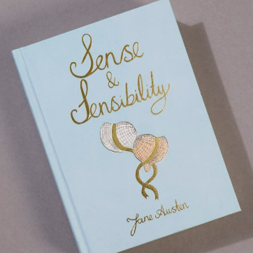 Book titled 'Sense & Sensibility' by Jane Austen with decorative cover on a plain background