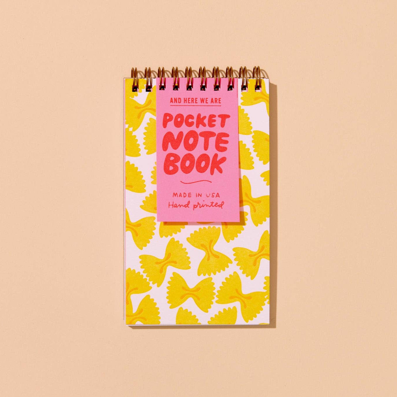 This best-selling little letterpress spiral notebook is hand printed with a colorful bowtie pasta pattern and made in a perfect, portable pocket-size size for everyday notes and lists. 60 lined pages, handmade in the USA.

Details:

Small pocket size letterpress printed spiral notebook
3.5" x 6" size fits in your pocket or purse