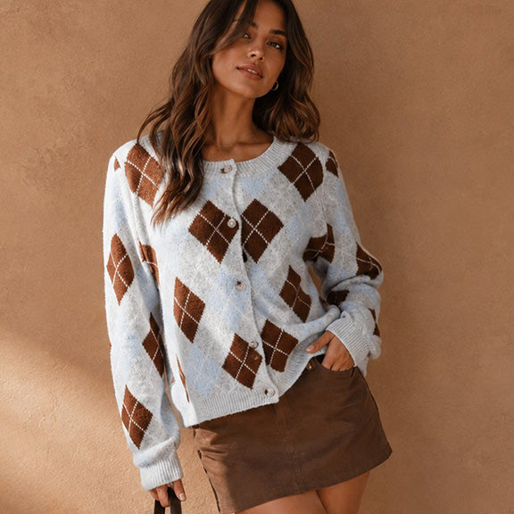 Sweater paired with a short brown skirt and boots. 