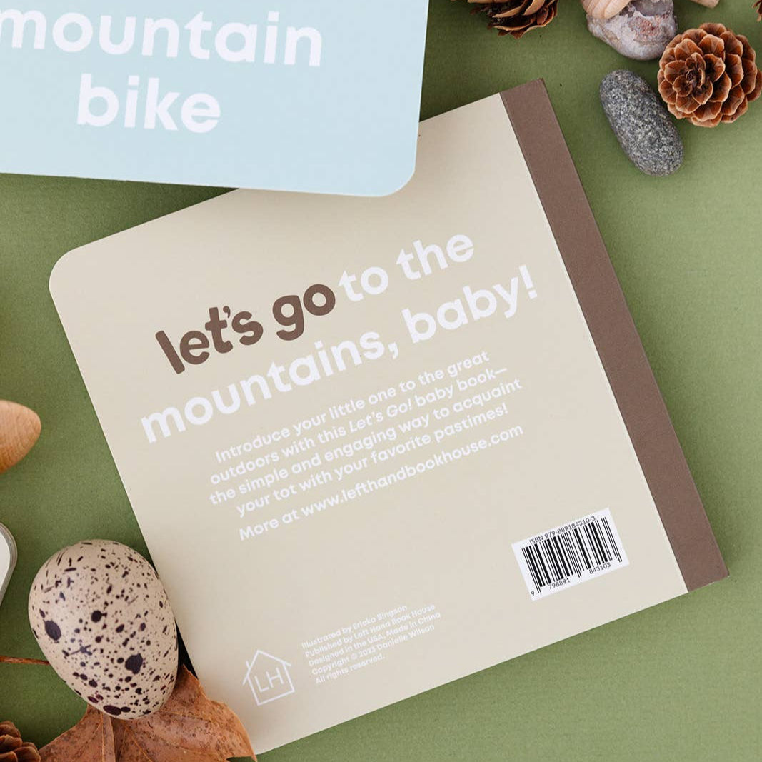 Book titled 'let's go to the mountains, baby!' with mountain bike theme on cover