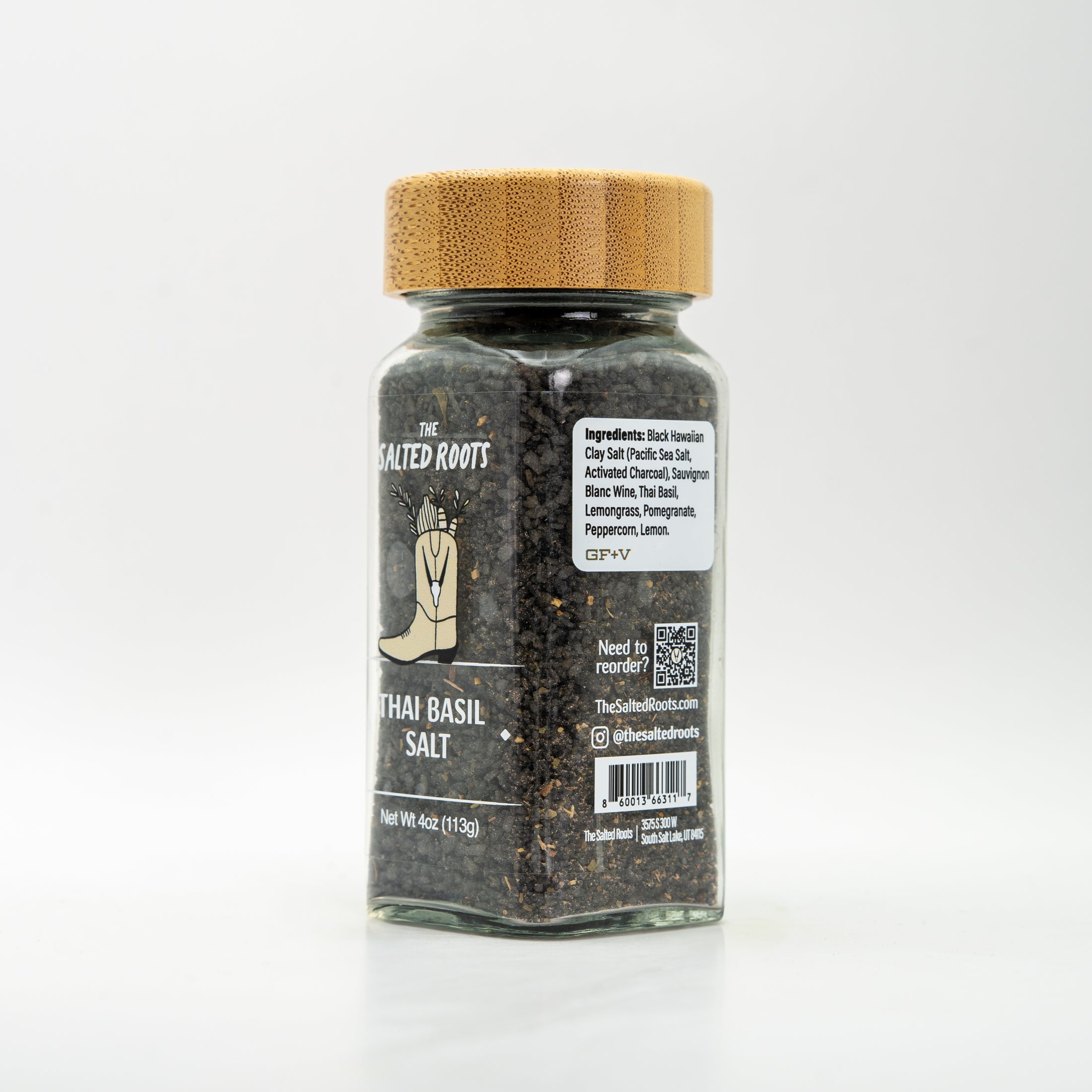 side view of glass jar with wooden lid and labels. 