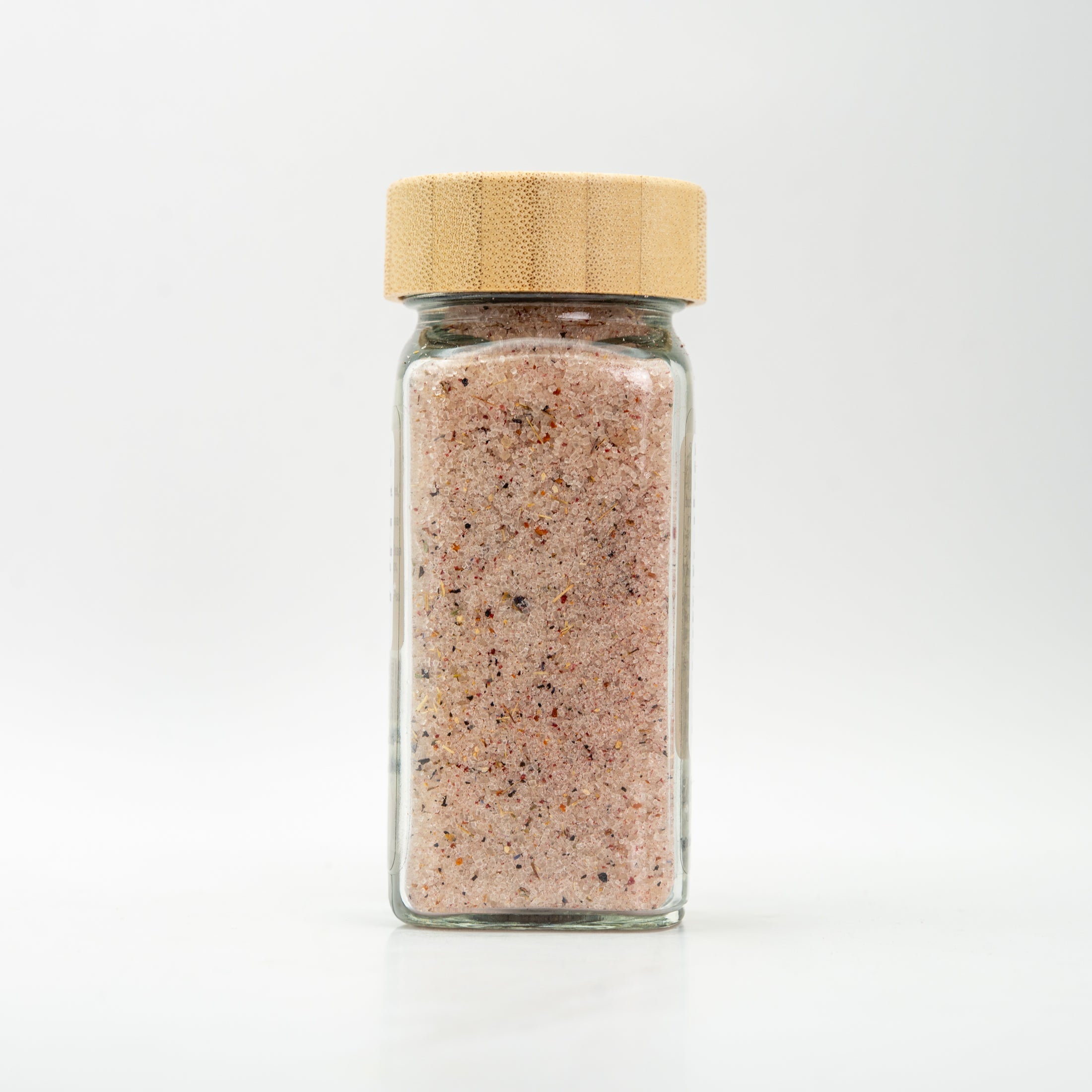 Unlabeled glass jar with wooden lid. 