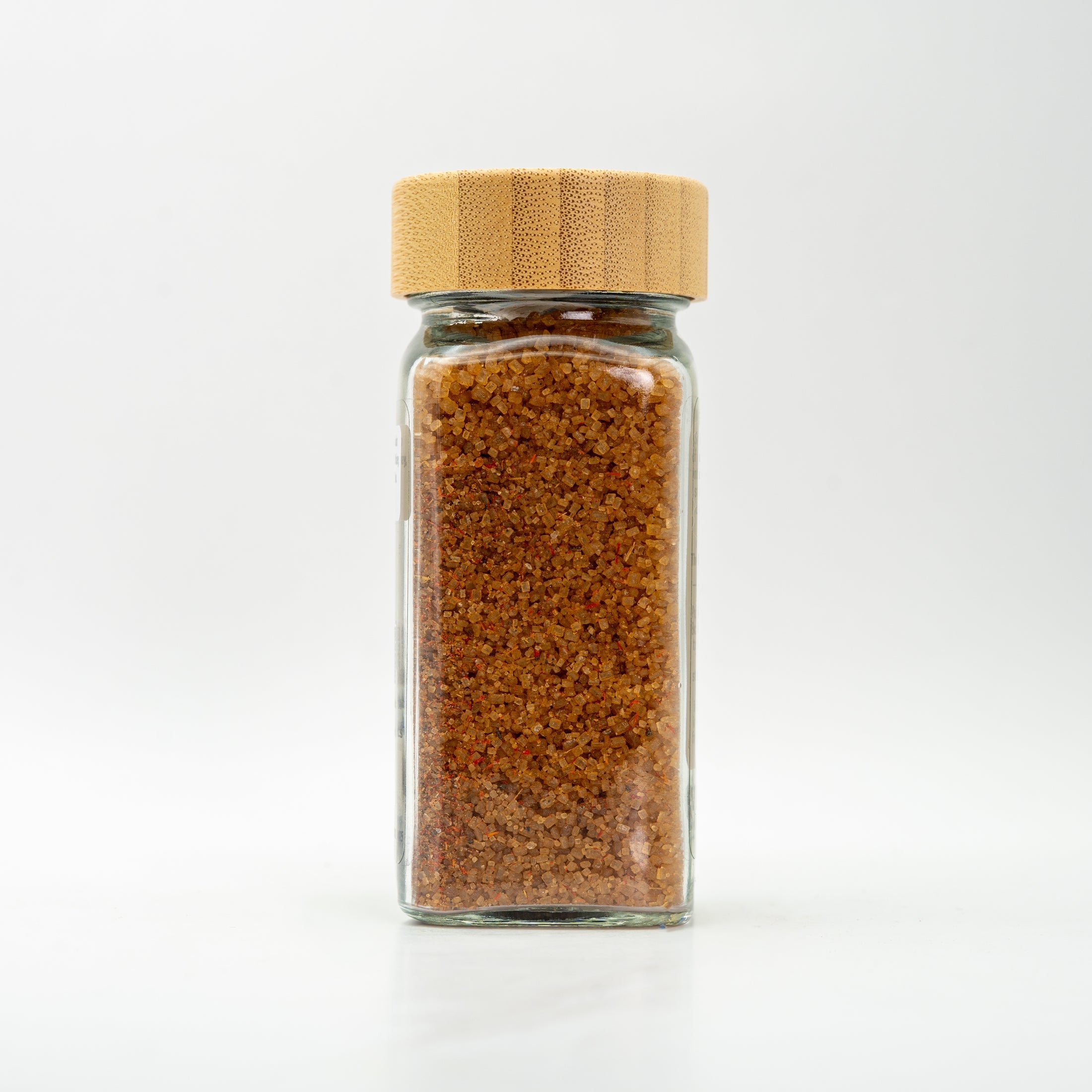 unlabeled glass salt jar with wooden lid.