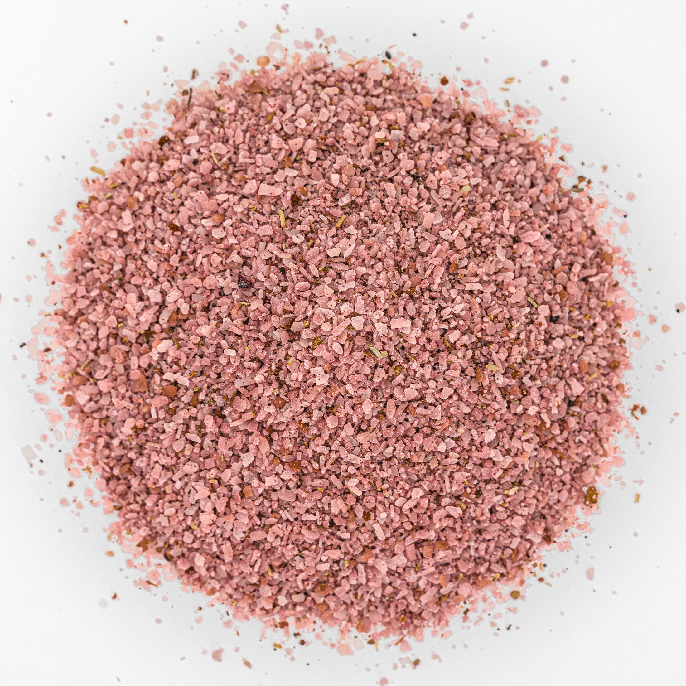 Mound of dark pink salt with flecks of herbs and spices. 