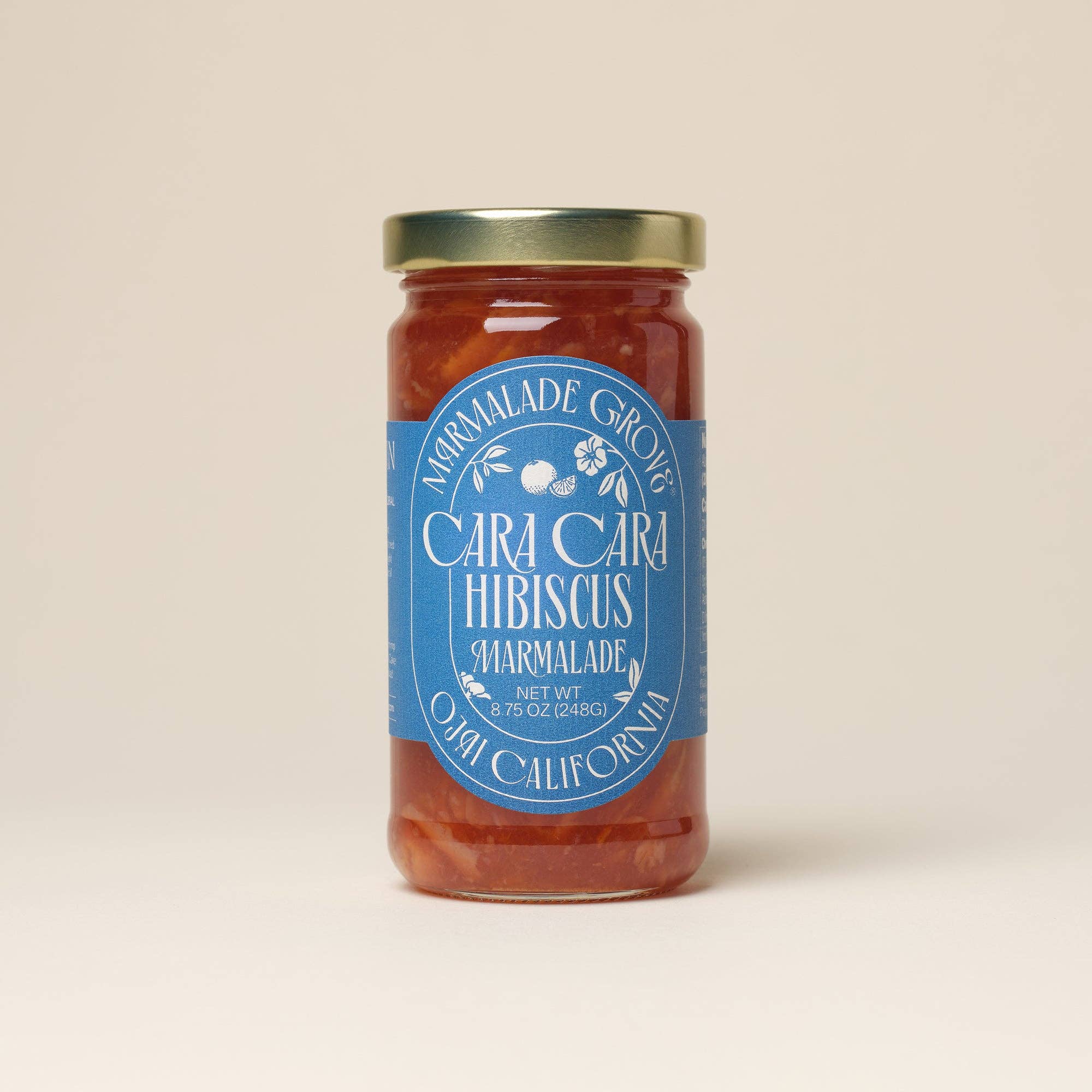 Jar of Cara Cara Hibiscus Marmalade with a blue label on a beige background