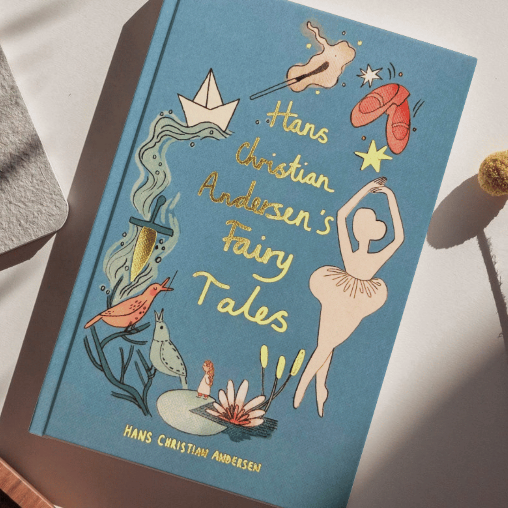 Book titled 'Hans Christian Andersen's Fairy Tales' with illustrations on a white surface.