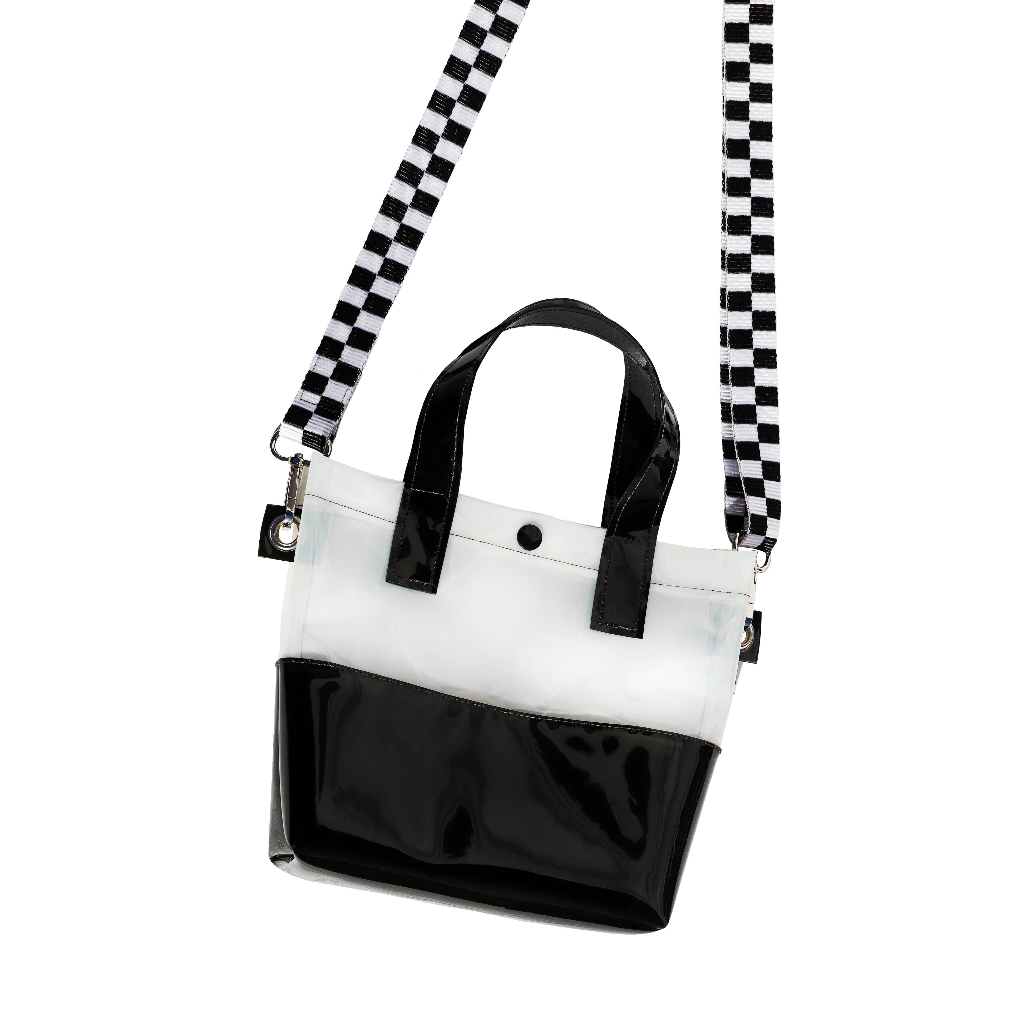 Miss your jelly sandals? This is your new favorite bag! Keep everything inside with a snap. The black and white translucent vinyl handle bag has a black snap closure and is detailed with silver metal grommets. It's available with or without the detachable black and white checkered 1" strap