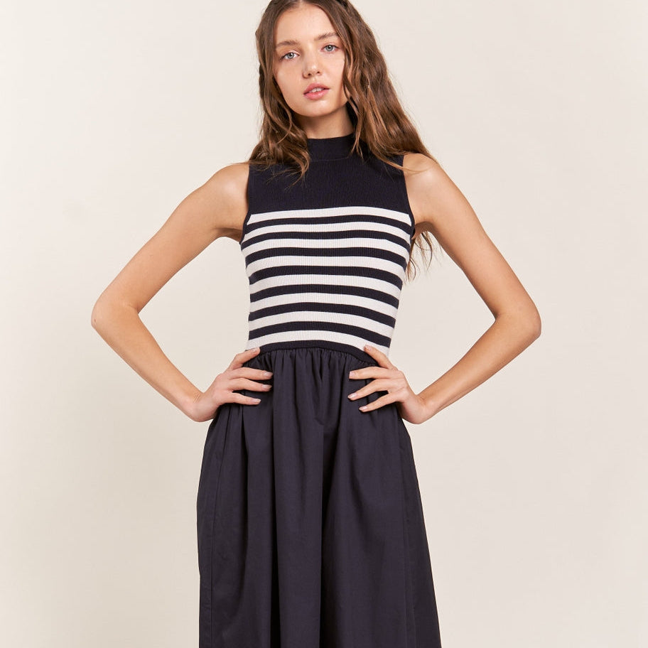 Get ready to strut your stuff in this Navy Striped Sleeveless Mock-Neck Maxi Dress. With its bold stripes and stylish mock-neck design, you'll be turning heads wherever you go. Perfect for a sunny day out or a night on the town. Express your unique style with this fun and chic dress!
Mock neckline, Sleeveless bodice, Fitted stripe top, Loose fit bottom, Maxi/ankle length dress, Self: 50% Viscose, 28%Polyester, 22% Nylon, Contrast: 100% Cotton