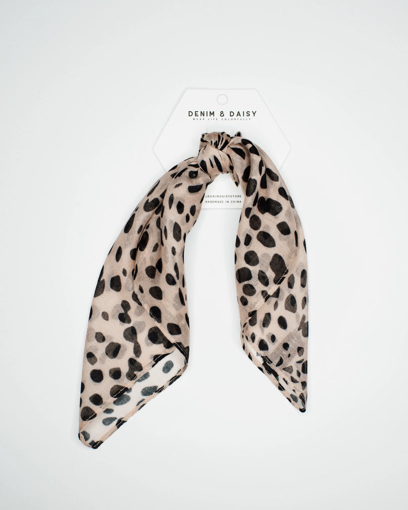 Don't just blend in—stand out with our Cheetah Bandana! Featuring a wild cheetah pattern, this chic accessory is crafted with buttery soft fabric so you can look fierce without feeling uncomfortable. Style traditionally or accessorize your braid, bun, neck, or bag! This classic hair wrap can be styled in so many trendy ways. Plus, it won't slide out of your hair like a regular ole bandana, so you can wear it all day!