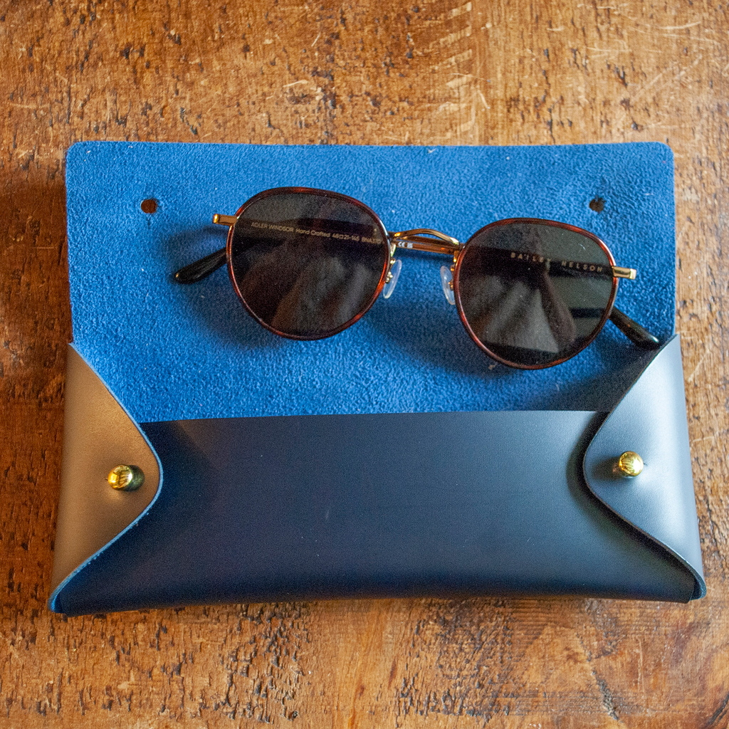 Stitch your own way - this envelope pocket is ideal as a pencil or glasses case and allows you to sew any unique design. Whether you stitch initials, a slogan or the sunglasses template included, it opens out fully for easy stitching. It also opens 2 ways, so it can open from the side or from the top - just pop the metal buttons to fold up whichever way you prefer. The Navy pouch comes with teal & gold thread &amp; needle wrapped on our pen thread-board. It includes our 3D alphabet template to add initials