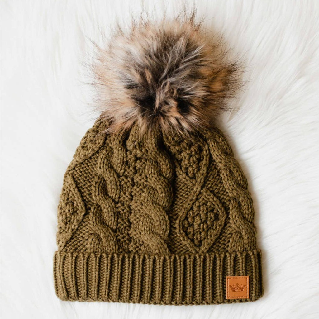 Add some sophistication and style to your cold-weather wardrobe with this muted olive cable knit pom hat featuring a floral patterned cuff! Ideal for breezy days, this hat will keep you feeling cozy and cute all season long.     Material  100% acrylic  Fleece lined