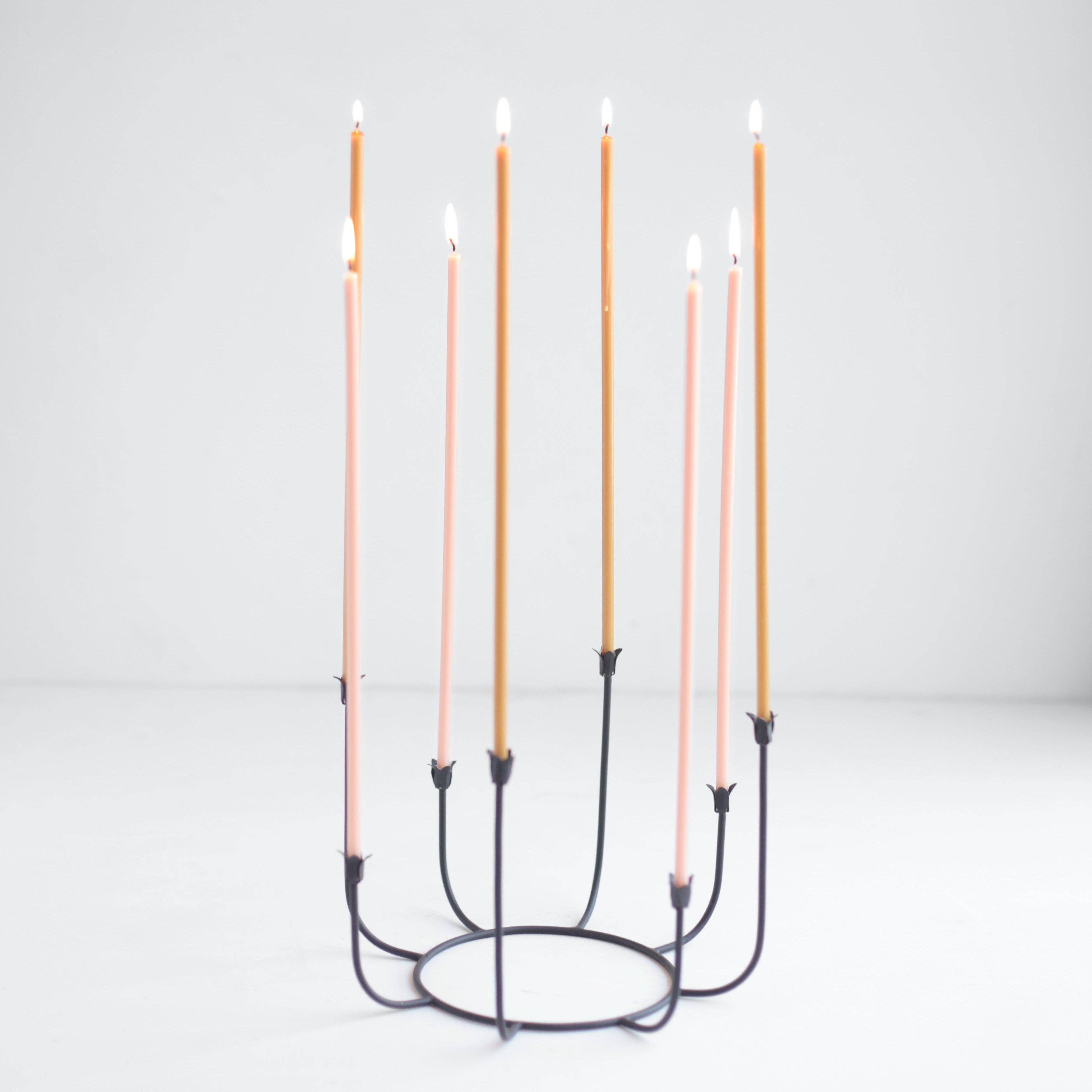 Candle holder with six candles on a white background