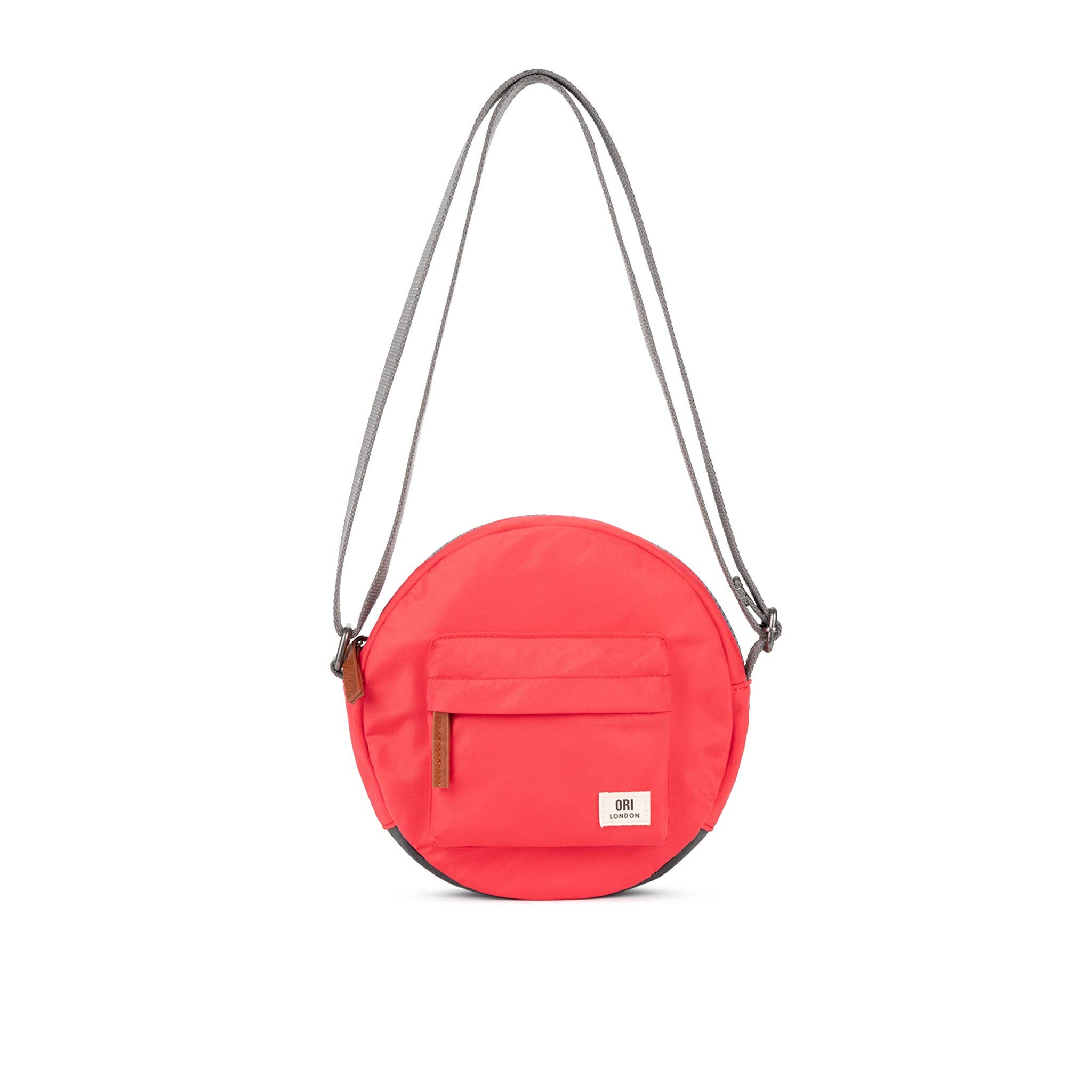 Over the shoulder and crosstown, our Paddington Crossbody is the perfect round bag to sling across your body and take on your day.

The Paddington bag has three pockets and sections to keep everything organized, safe and secure, all in weather-resistant, recycled material.

The size is the perfect accessory to store all your daily necessities - mobile, wallet, keys, and more! Our Paddington Crossbody is the only, stylish round bag out there. Poppy pink color