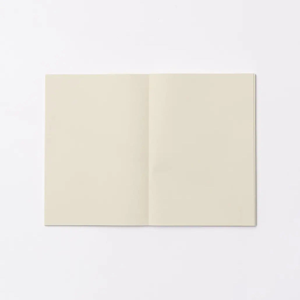 An open blank notebook with cream-colored pages, displayed flat against a clean white background.