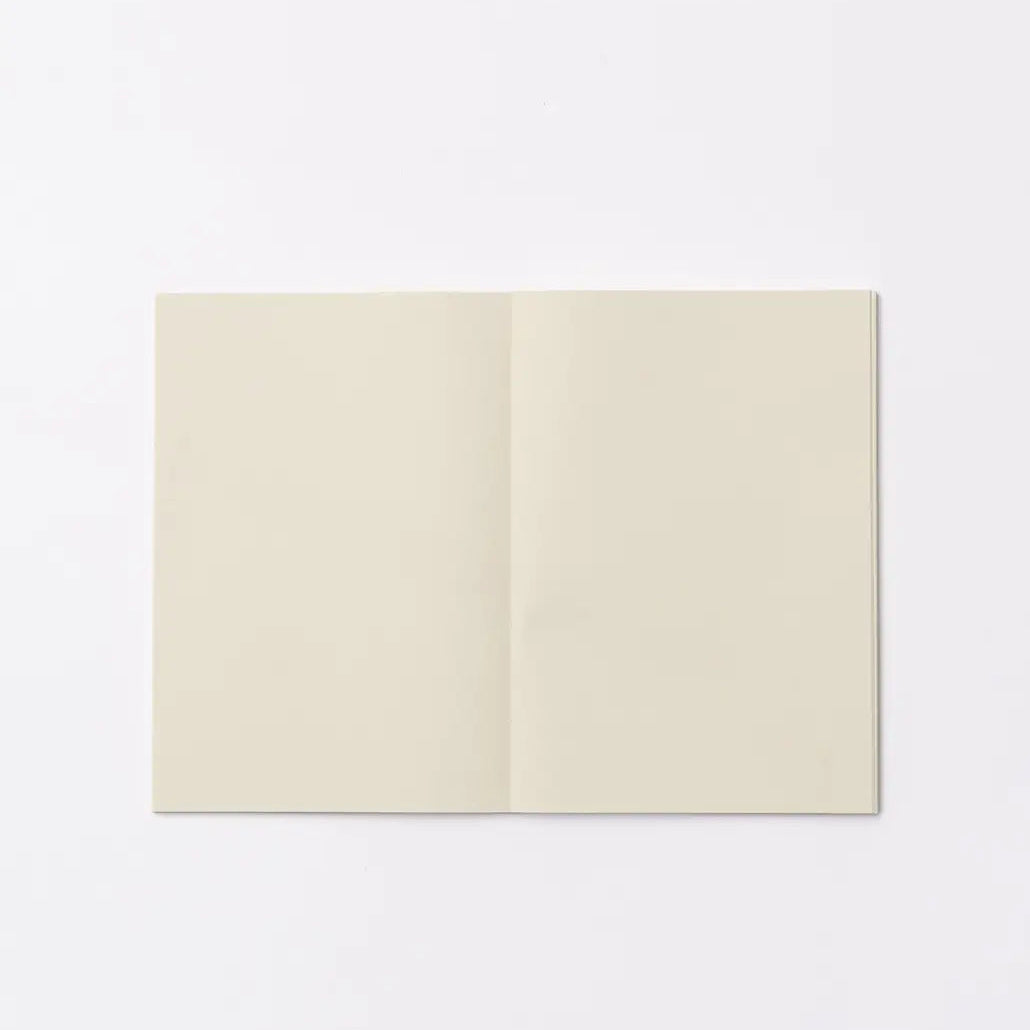 An open blank notebook with cream-colored pages, displayed flat against a clean white background.