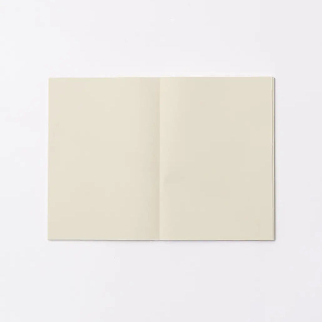 An open blank notebook with cream-colored pages, displayed flat against a clean white background.
