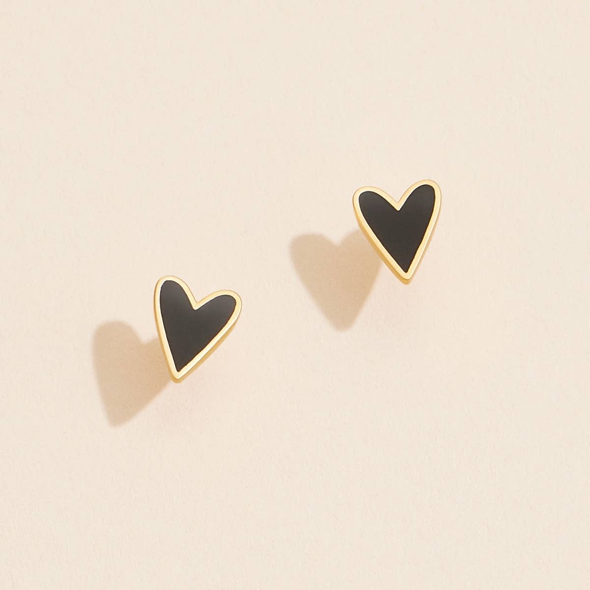 Fall in love with our Enamel Heart Shaped Stud Earrings! These charming earrings feature delicate enamel hearts that add a touch of loveliness to any outfit. Treat yourself or your loved one with these beautiful studs today!