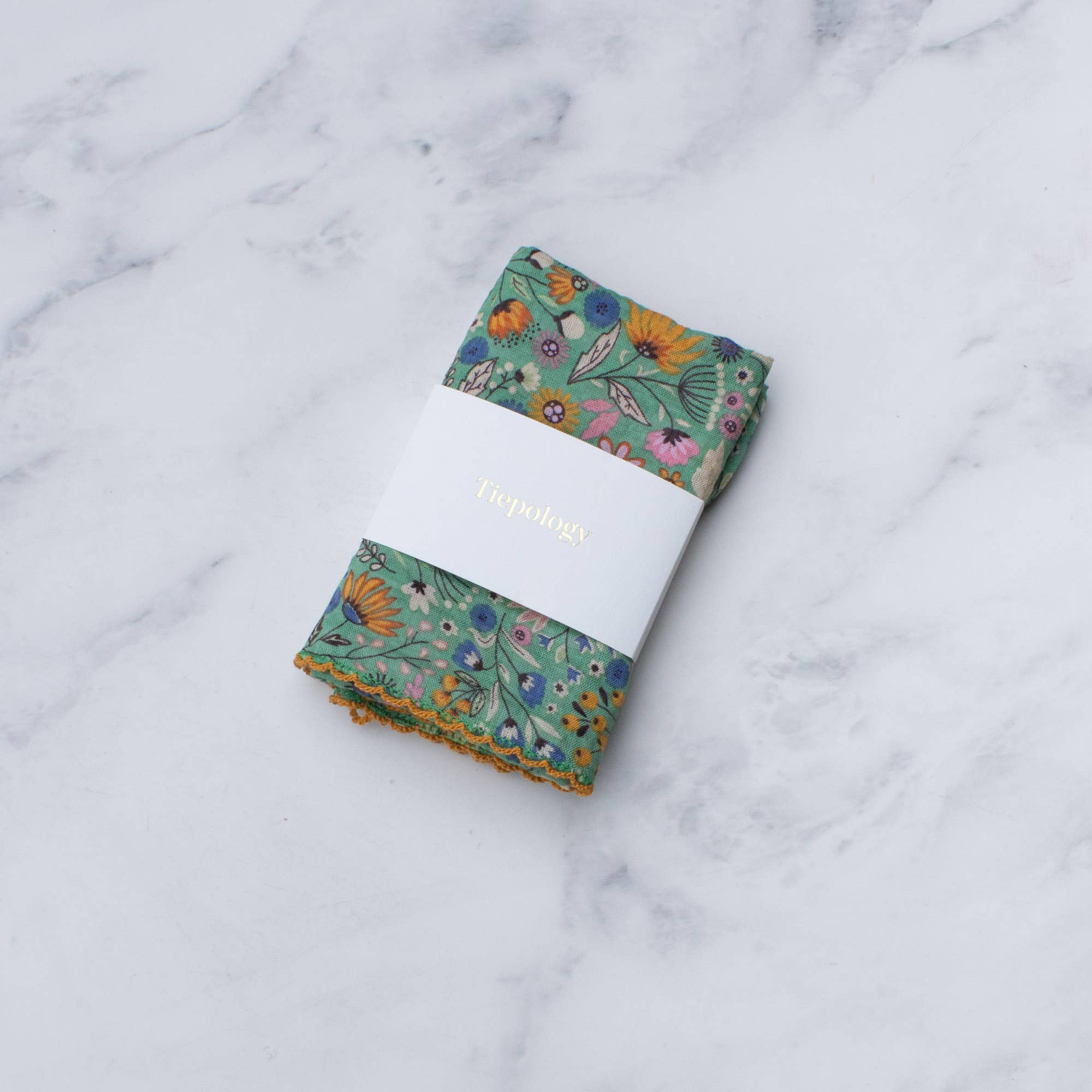 Folded floral fabric on a marble surface